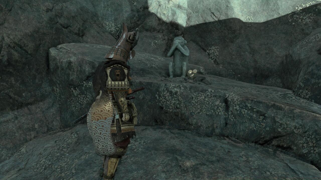 The last monkey can be reached when you cross a bamboo footbridge to find a path you can climb down using your grappling hook. Descend to a small pond below and swim across it to find the last statue. Bow before it to activate it.