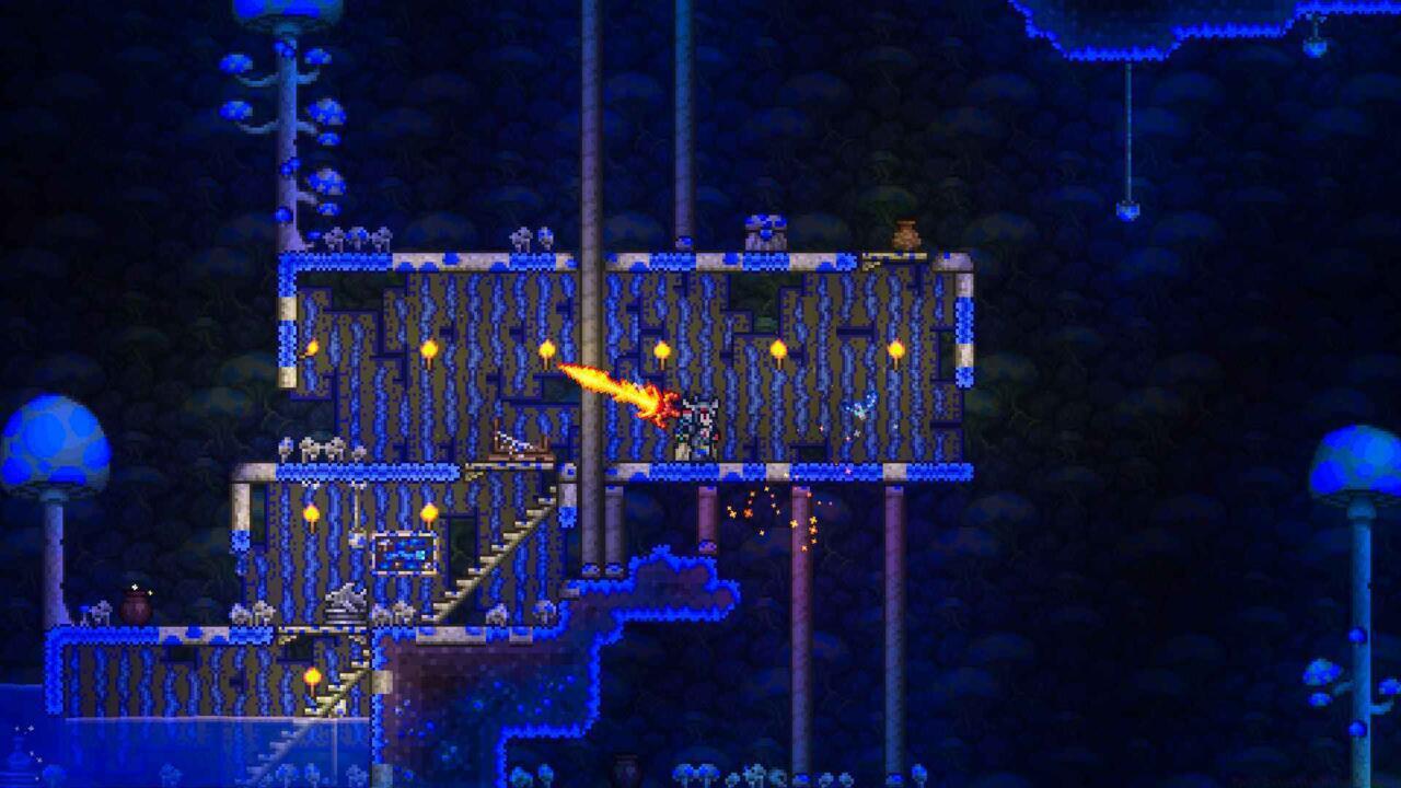 Terraria player swinging the molten sword engulfed in fire overhead.