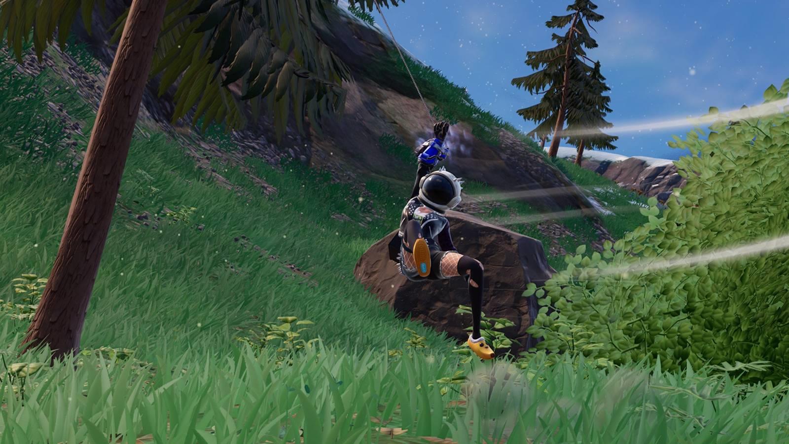 A character from Fortnite who is wearing Peely slippers and an astronaut helmet swinging from a tree using a grapple glove.