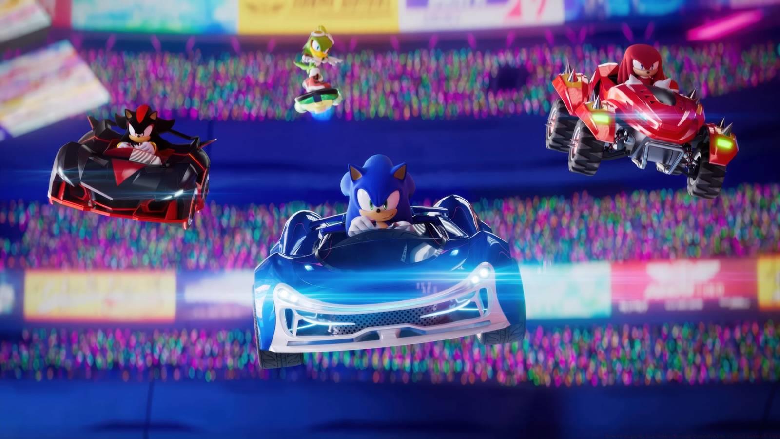 Sonic, Shadow, and Knuckles driving cars and Jet the Hawk riding a board in Sonic Racing: CrossWorlds.