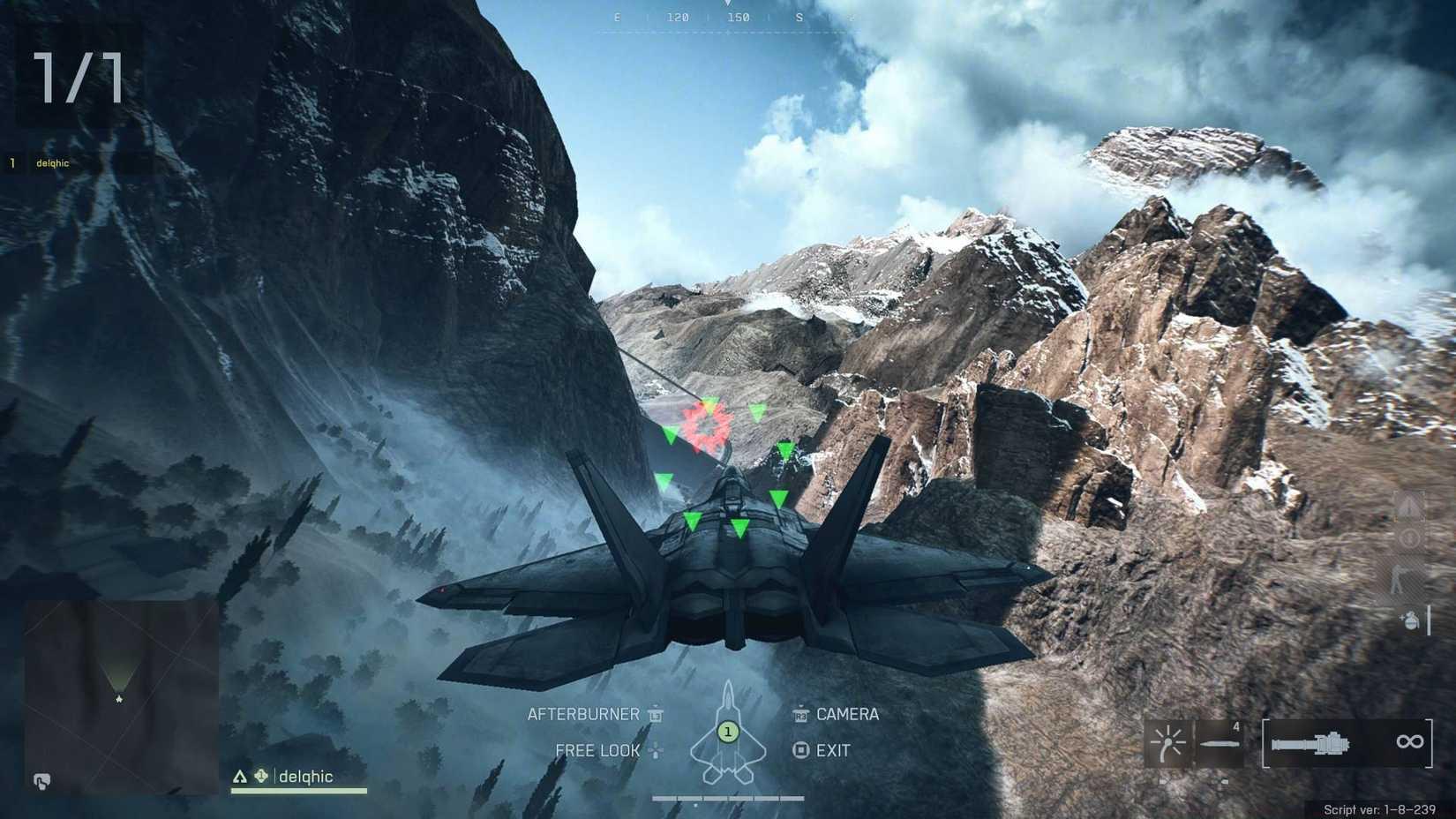 The player flying a jet through some snowy mountains towards a checkpoint.