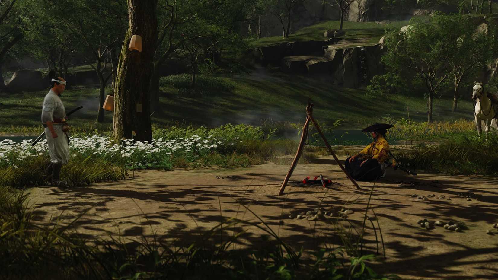 A Ghost of Yotei screenshot showing Atsu sitting in front of a campfire and Smiling Yoshimoto standing in front of her